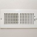 HVAC vent cover on wall, illustrating potential causes of poor airflow in home heating and cooling systems.